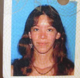 my 24 year old self on my drivers license long brown hair with bangs close lipped smile so young and pretty