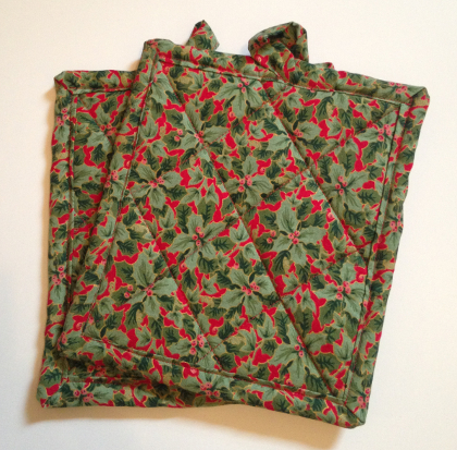 holiday potholders green holly leaves on red background