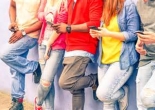 shoulders down image of teens holding cell phones